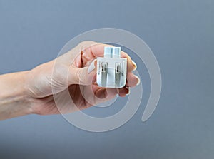 Hands holding various converter cables adapters for computers and smartphones