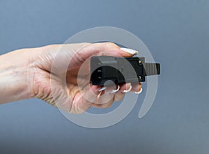 Hands holding various converter cables adapters for computers and smartphones