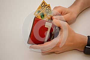 Hands holding wallet with australian dollars