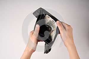 Hands holding wallet with coins money on white background