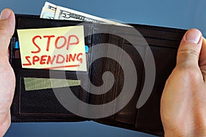Hands holding wallet with stick Stop spending. photo