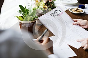 Hands Holding Wedding Planner Checklist Information Preparation