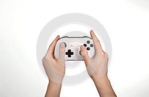 Hands are holding white gamepad isolated against a white background