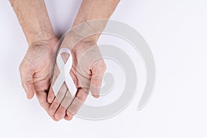 Hands holding white ribbon. White background