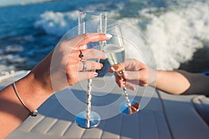 Hands holding wine glasses to clink photo