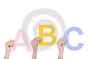 Hands holding the word ABC