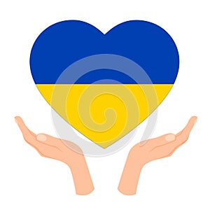 The hands holds the heart in the colors of the flag of Ukraine. The concept of peace in Ukraine.