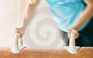 Hands, horse and gymnastics with a motion blur man in a gym, training for an olympics competition. Fitness, exercise or