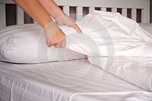 The hands of housewives who are changing sheets photo