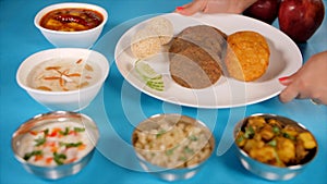 Hands of an Indian woman placing a thali of traditional Upwas/fasting food