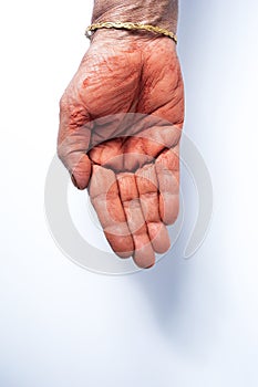 Hands of an Indian woman with red holi powder applied on hand isolated on white background