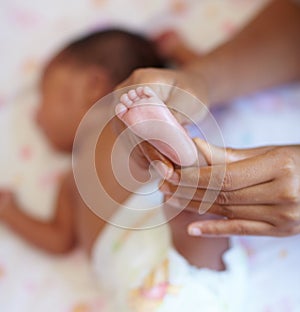 Hands, infant and closeup of a baby foot with mother holding for comfort, care and love. Childcare, cute and zoom of a