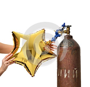 Hands inflate gold star balloon use Helium Tank with Economy Regulator Fill Valve photo