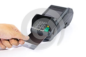 Hands insert blank black credit card into card machine isolated