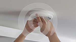 The hands installing smoke detector.AI generated image