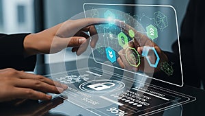 Hands interacting with futuristic holographic interface displaying security and data analytics