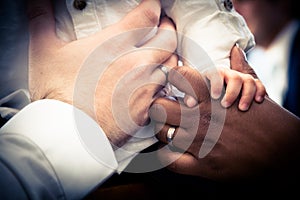 Hands of Interracial couple with child photo