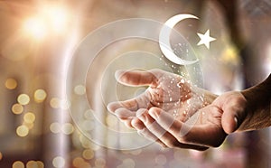 Hands and islamic symbol floating with glitters and religious background photo