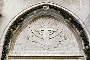Hands of Jesus with Holly wounds at ancient catholic church facade