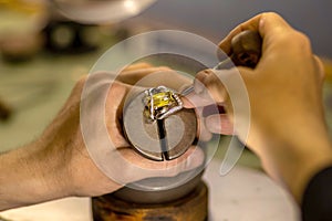 Hands of a jeweler with a ring