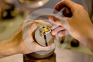 Hands of a jeweler with a ring