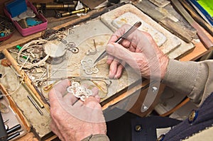 Hands of jeweller photo