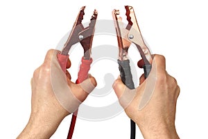 Hands with jumper cables on white