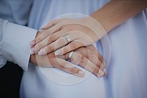 Hands of a just married couple with wedding rings
