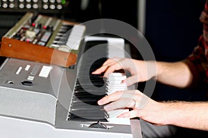 Hands on keyboard of electric organ