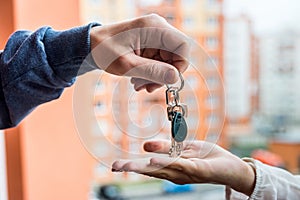 Hands with keys from new apartment and dollar bunch