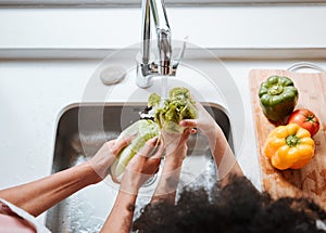 Hands, kid and parent by sink, vegetables or above for cleaning, faucet or water for teaching, cooking or home. Person