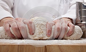 Hands kneading bread dough