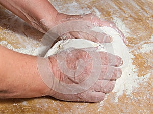 Hands kneading a dough