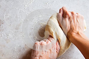 Hands kneading dough