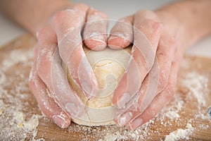 hands kneading and shaping dough