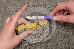 Hands Knitting Thick Wool with Large Crochet Hook