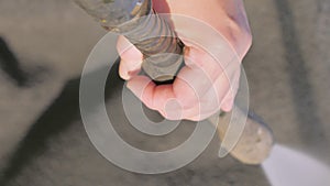 The hands of the lady holding the power washer. Sprayed with a jet of water.