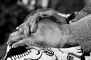 Hands on lap. Grandmother sitting with her hands on lap in black and white. Mothers day concept. Asian senior woman with wrinkle