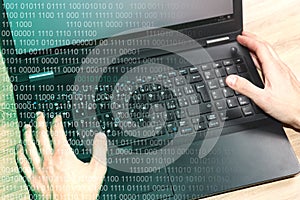 Hackers laptop with binary code.