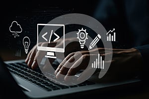 Hands on laptop keyboard with holographic coding and analytics icons, illustrating software development, data, cloud, and digital