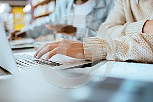 Hands, laptop and typing on keyboard for research, browsing or learning at campus library. Hand of student working