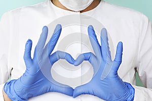 Hands in latex glove shows the symbol of the heart. Doctor for the heart. Love our medical professionals