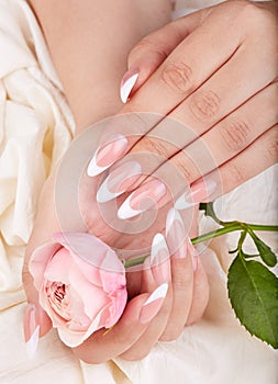 Hands with long artificial french manicured nails photo