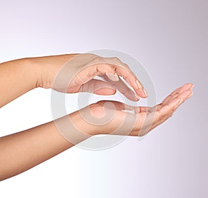 Hands, lotion and beauty, skincare and woman, manicure and nail polish with cosmetics on studio background. Sunscreen