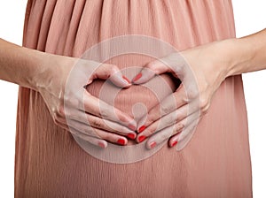 Hands are lying on the stomach of a pregnant woman on a white isolated background