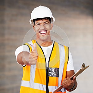 These hands are magic. a young contractor showing the thumbs up at work.