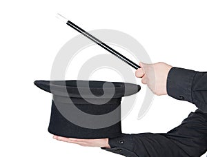 Hands of the magician with magic wand and top hat
