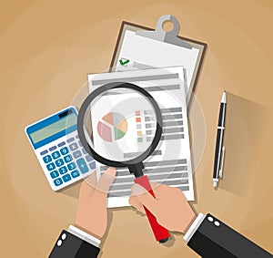 Hands with magnifier analysis paper sheet