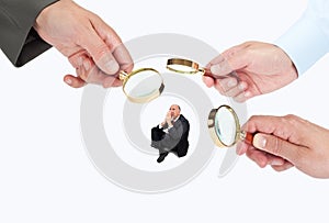 Hands with magnifier glasses looking, studying or selecting a person