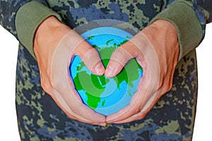Hands Make Heart Shape over a Tiny Verdant Globe